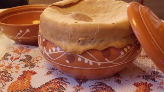 Lean cabbage soup with cabbage, beans, mushrooms and prunes under a bread lid