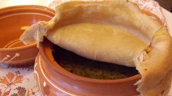 Lean cabbage soup with cabbage, beans, mushrooms and prunes under a bread lid